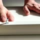 A Man a Handyman in a Blue Jumpsuit is Assembling a Table in Closeup - VideoHive Item for Sale