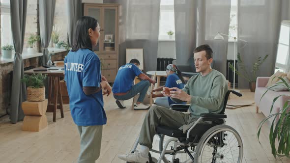 Man with Disability Meeting Volunteer at Home