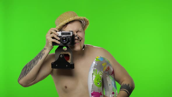 Shirtless Man Tourist Photographer Is Taking Photos on Retro Camera. Chroma Key