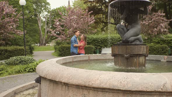 Young, happy, loving couple having date in the park. Relations, friendship and love concept.