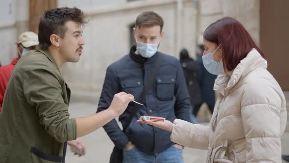 Magician Man Showing Street Magic Trick with Cards