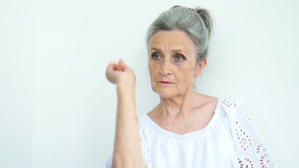 Closeup Portrait Angry Upset Senior Mature Woman is Raising Her Fist
