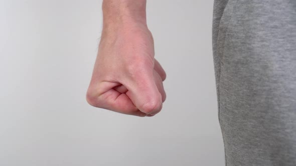 A man clenches his fist for physical home abuse