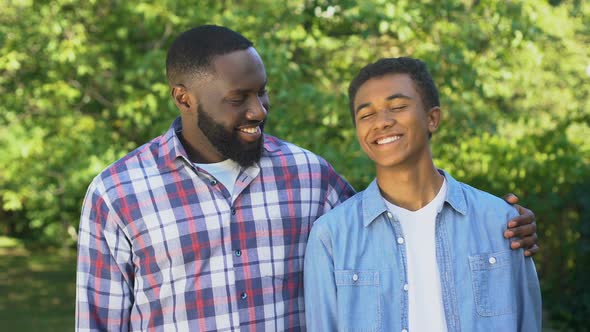 Cheerful Black Dad and Son Smiling on Camera, Trustful Relations, Friendship