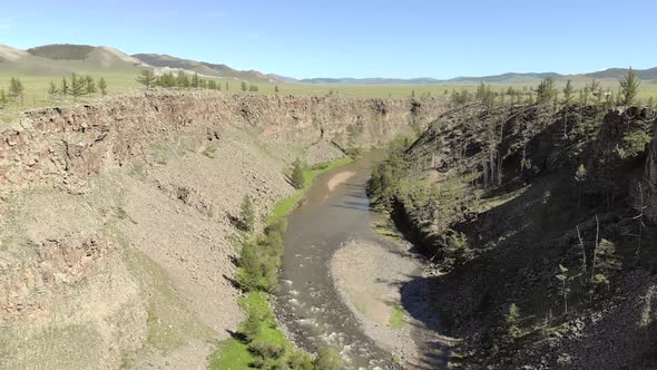 Broken Crumbled Rocks Spilling From the Narrow Canyon Slope Ridge Towards the Deep Valley Floor