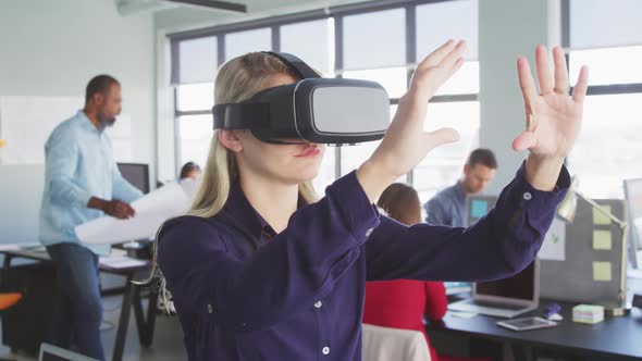 Businesswoman using VR headset in modern office