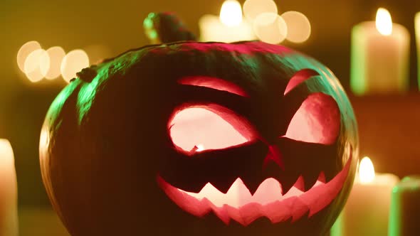 Jackolantern and Blowing Burning Candles Closeup