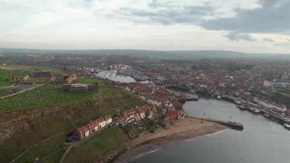 Aerial view of Whitby Harbour. Here we can see a narrow stream many houses are seen on either side o