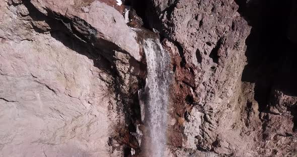 Narrow river flow through a beautiful valley in Alborz mountain fall down the cliff waterfall in col