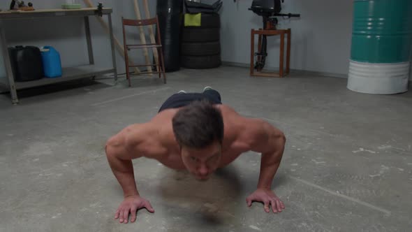 Man Without a T-shirt Does Push-ups on the Floor