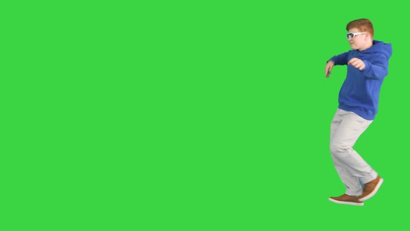 Teenager Boy Walking By and Dancing on a Green Screen Chroma Key