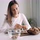 Young Woman Is Cracking a Walnuts at Domestic Room - VideoHive Item for Sale