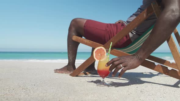 Senior man on deck chair with a cocktail