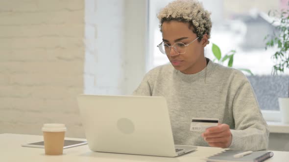 African Woman Making Online Payment Failure on Laptop in Office