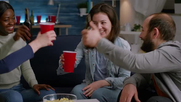 Multiethnic Friends Spending Time Together Cheering Beer Bottles