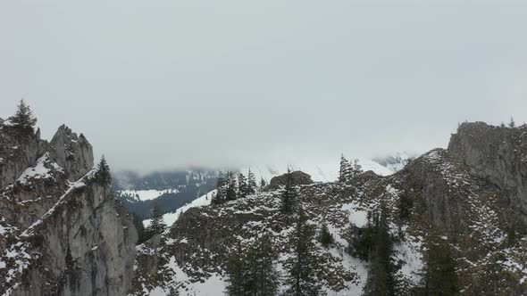 Aerial of mountain ledge with a reindeer suddenly running downhill