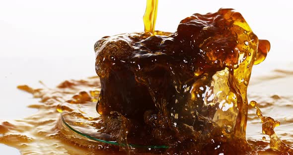 Coffee Being Poured in a Cup against White Background, Slow motion