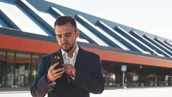 Elegant businessman in airport. Young mail entrepreneur in formalwear.