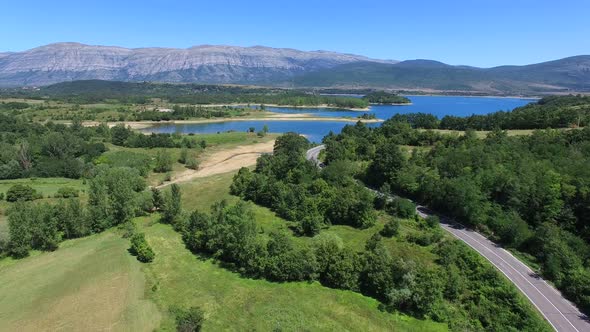 Aerial view of highway through green forested hills, Croatia