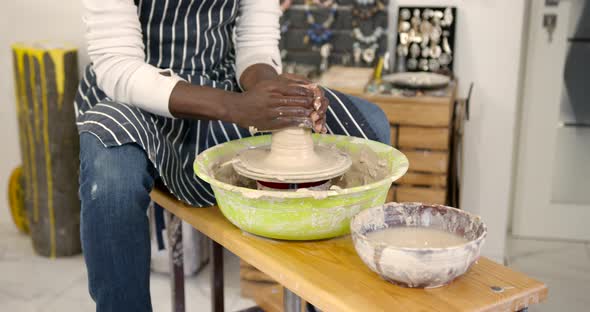 Young Black Man Working on Pottery Wheel at Workshop