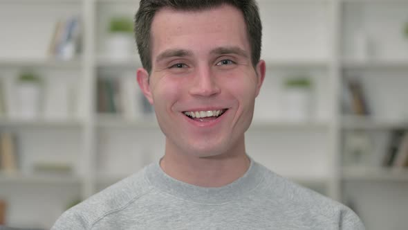 Portrait of Cheerful Young Male Designer Doing Video Call