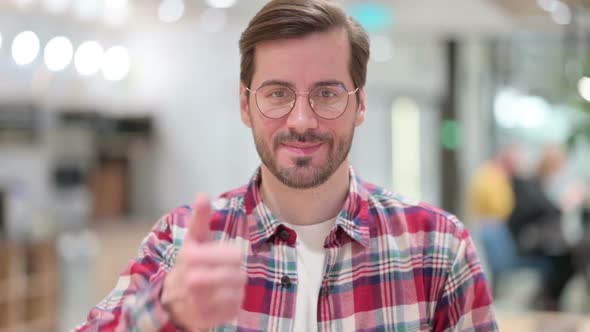 Positive Male Designer Doing Thumbs Up