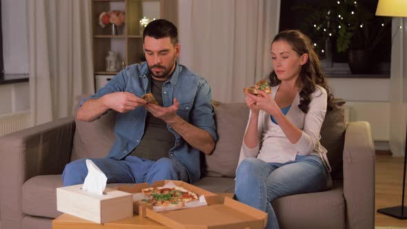 Happy Couple Eating Takeaway Pizza at Home
