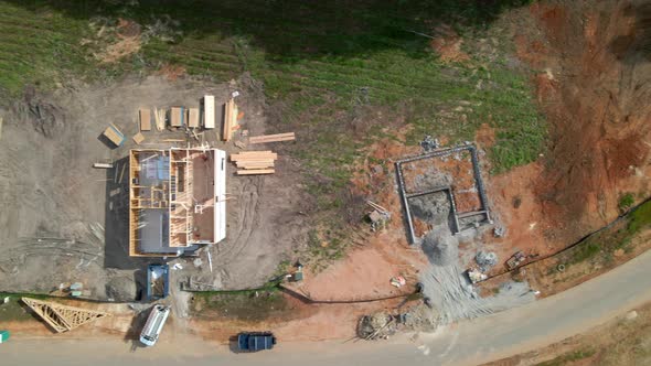 Cinematic downward angle drone shot of homes being built, new construction