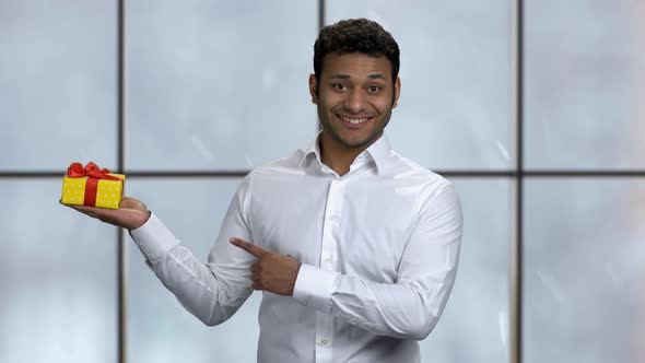 Businessman Pointing at Gift Box with Finger