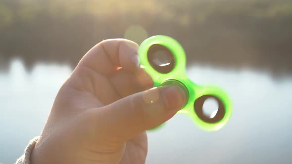 Young Man Playing with Fidget Spinner, Slow Motion.