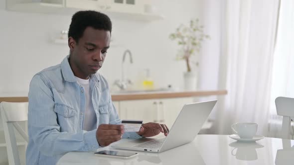 Successful Online Shopping on Laptop By African Man at Home