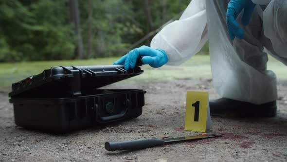 Criminalists Discovering Proofs at Crime Scene Closeup Taking Evidence From Accident Murder