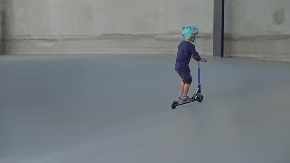 7-Year-Old Boy Riding Scooter at Skatepark