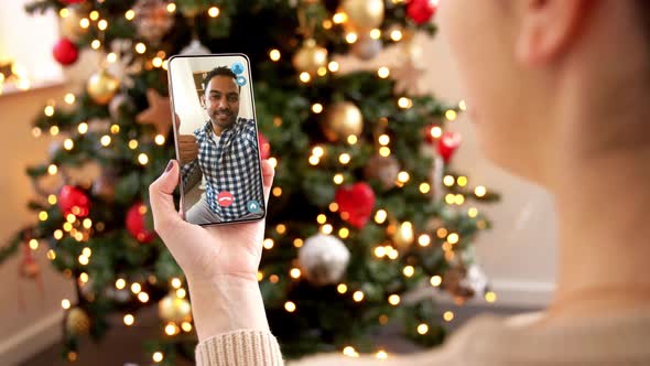 Woman with Smartphone Has Video Call on Christmas