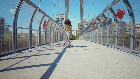 Beautiful young woman cruising around the city with her longboard.