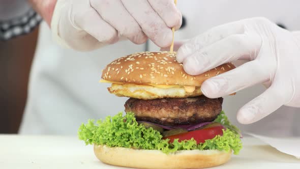 Hands of Chef and Burger.