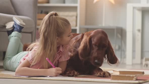 Girl with Dog Resting on Floor at Bedroom