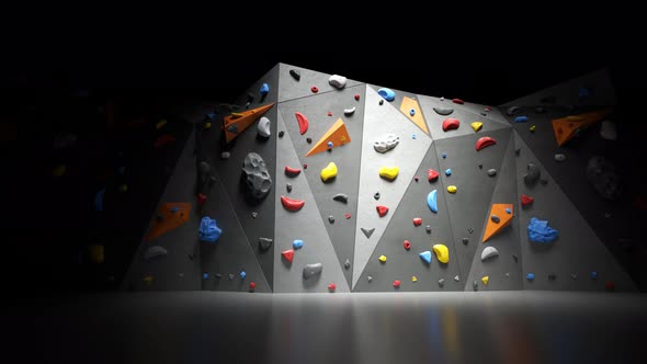 Indoor bouldering wall with colorful climbing holds. Gym indoor extreme training