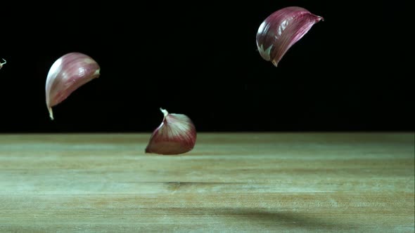 Garlic clove pieces bouncing in ultra slow motion 1500fps on a wooden surface - BBQ PHANTOM 033