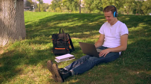 Portrait Young Man with Computer Resting Outdoors