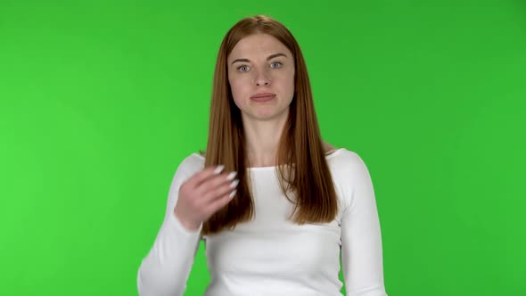 Portrait of Pretty Young Woman Is Cooling Herself By Her Hand, Suffering From High Temperature