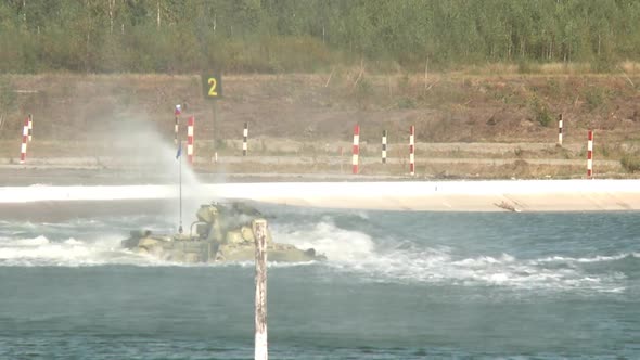 A Combat Armored Vehicle Enters the Water at Full Speed Then Swims Through a Water Obstacle