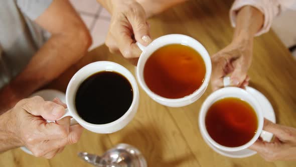 Group of senior friends toasting coffee cups 4k