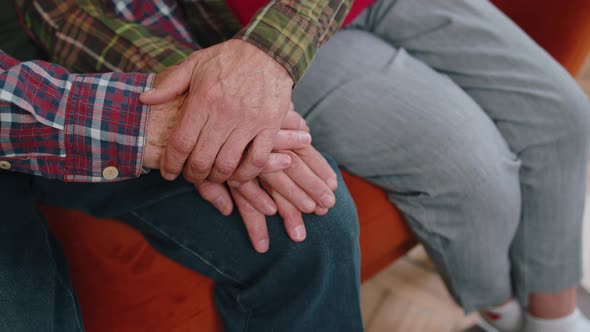 Close Up of Caring Elderly Grandmother Wife Holding Hands Supporting Senior Grandfather Husband