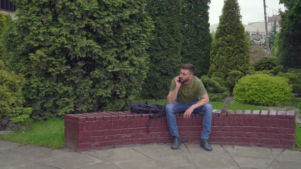 Young Stylish Man Feels Depressed During Mobile Conversation