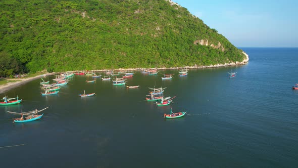 Many fishing boats on the coast beside the mountains, beautiful sea area in Thailand.