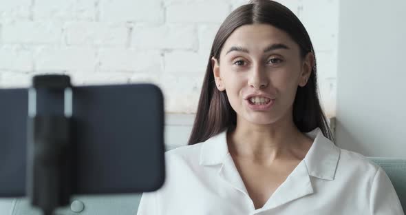 Female Vlogger Chatting on a Video Call with Friends Using Her Phone