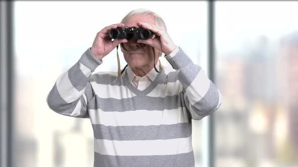 Senior Male Looking Through Binoculars.