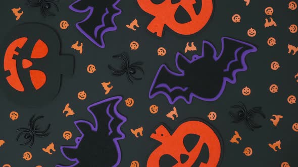 composition of Halloween decorations,pumpkins,bats, spiders,cobwebs rotate on an black background.4k