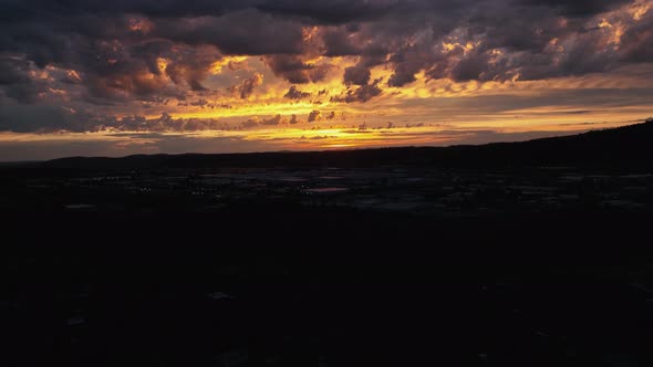 Rising aerial shot of a golden sunset in Spokane, Washington.